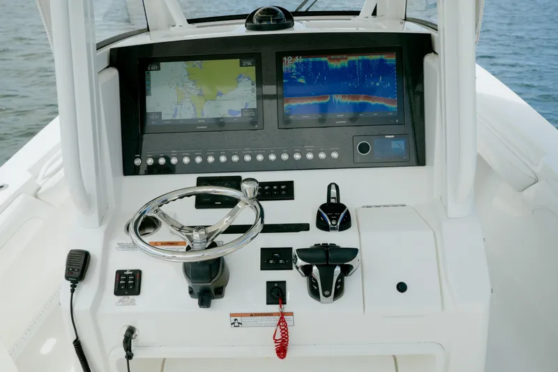 Slide: The Image of Control panel of a 2021 Regulator 28 Forward Seating boat with navigation screens. - 12