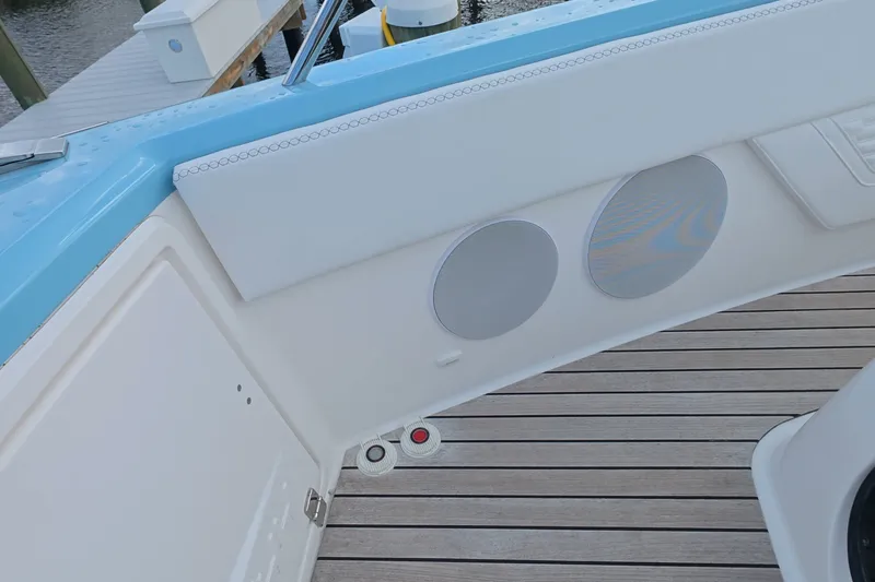 Slide: The Image of Interior view of 2025 Schaefer V44 yacht with speakers and wooden deck. - 15