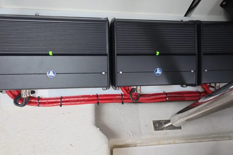 Slide: The Image of Electrical components in a 2025 Schaefer V44 boat with red wiring. - 59