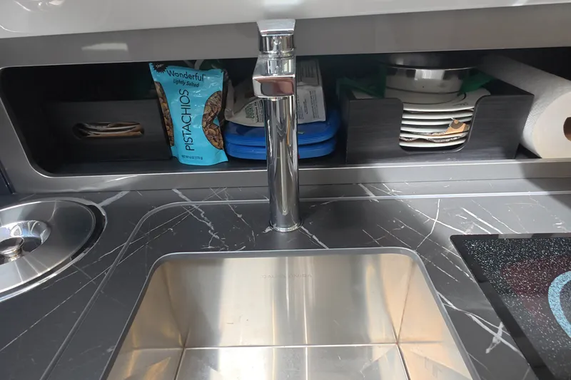 Slide: The Image of Modern kitchen sink area in Schaefer V44 yacht, featuring sleek faucet and storage. - 45