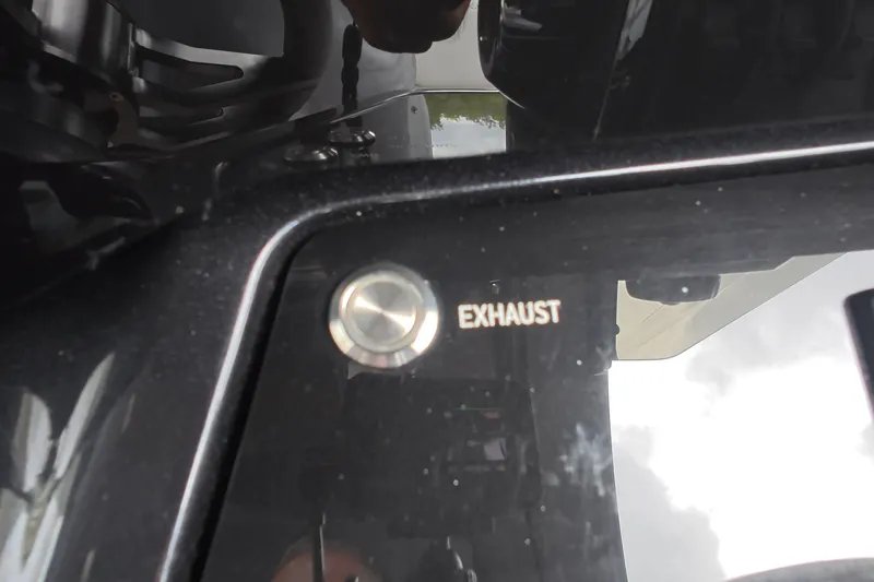 Slide: The Image of Close-up of Schaefer V44 2025 exhaust button on a glossy black panel. - 42