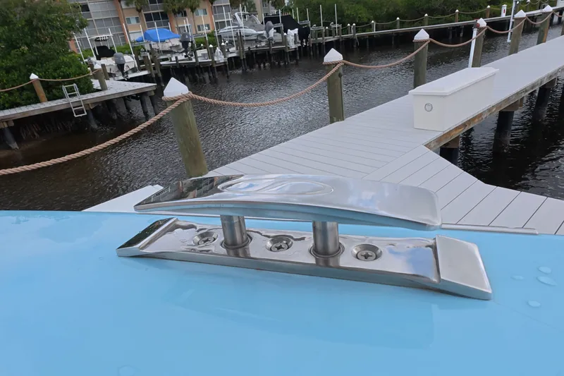 Slide: The Image of Schaefer V44 2025 boat cleat on blue deck near marina dock. - 24