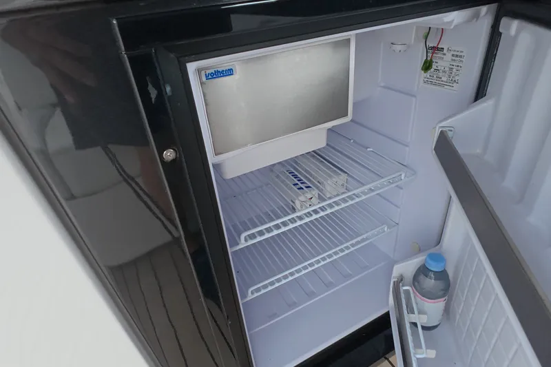 Slide: The Image of Open Schaefer V44 refrigerator, 2025 model, with shelves and a bottle in the door. - 31
