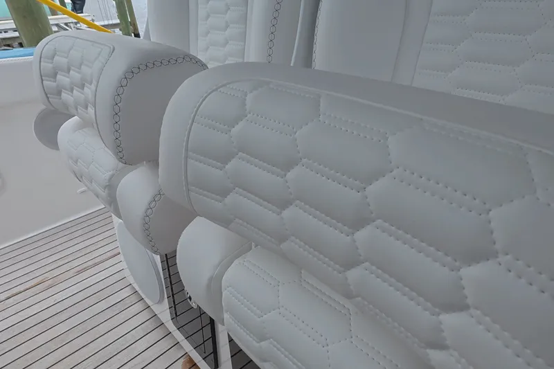 Slide: The Image of Luxurious white seating on 2025 Schaefer V44 yacht with detailed stitching. - 14
