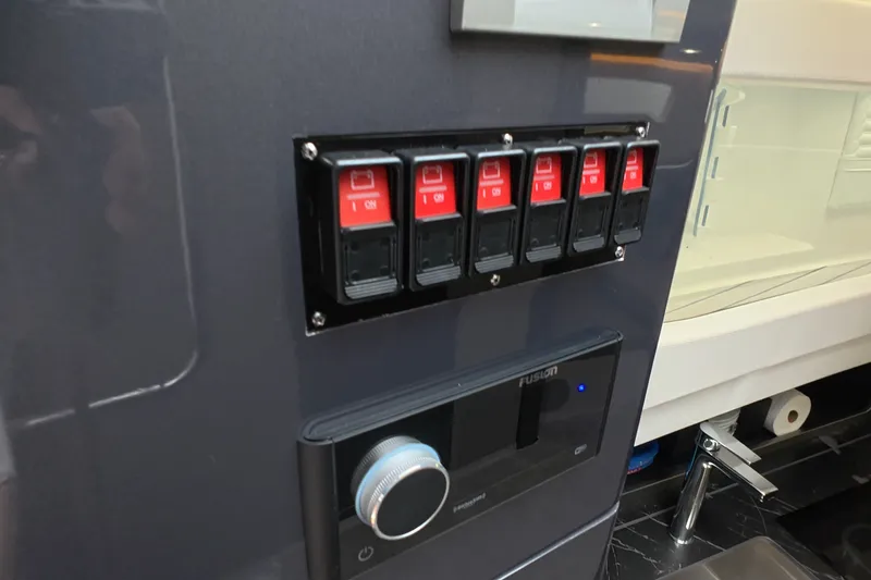 Slide: The Image of Control panel with switches and a knob on a 2025 Schaefer V44 yacht. - 39