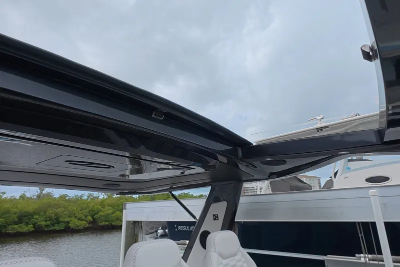 Slide: The Image of 2025 Schaefer V44 yacht interior with open sunroof, showcasing sleek design and luxury seating. - 30
