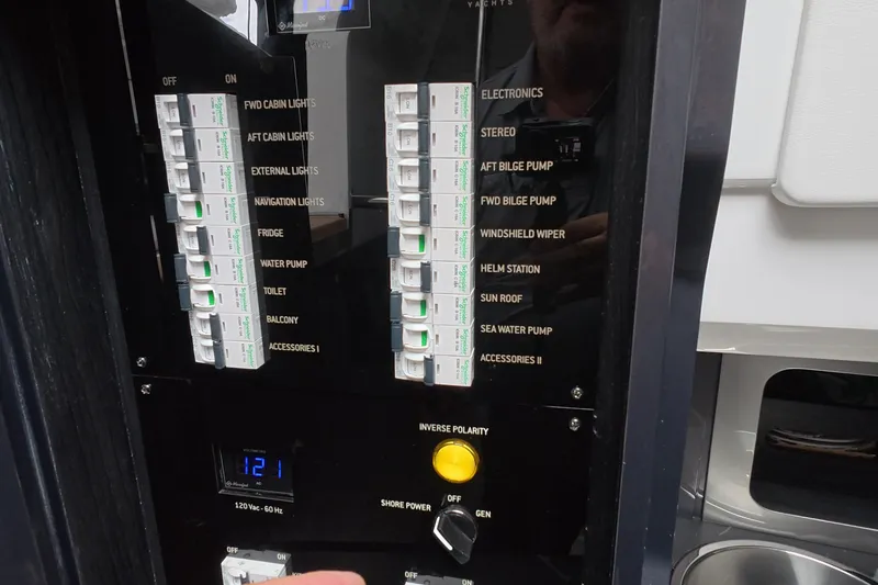Slide: The Image of Electrical control panel of 2025 Schaefer V44 yacht with labeled switches and voltage display. - 50