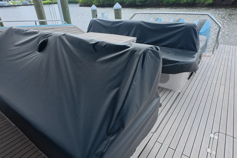 Slide: The Image of Covered seating area on a 2025 Schaefer V44 yacht deck by the water. - 52
