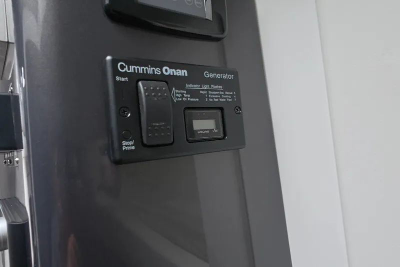 Slide: The Image of Cummins Onan generator control panel on Schaefer V44, 2025 model yacht. - 49