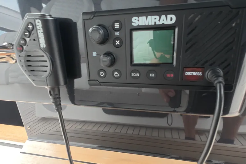 Slide: The Image of Simrad marine radio system on Schaefer V44 yacht, 2025 model, featuring distress button. - 41