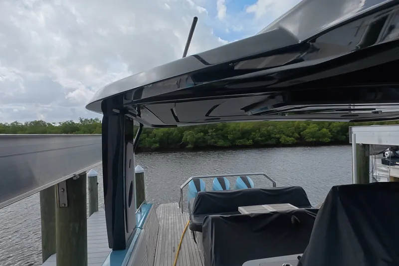 Slide: The Image of Schaefer V44 yacht docked by a serene river, showcasing sleek design and modern features. - 54