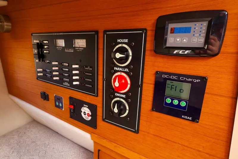 Slide: The Image of Control panel of 2023 Ranger Tugs R-27 boat with electrical switches and displays. - 39