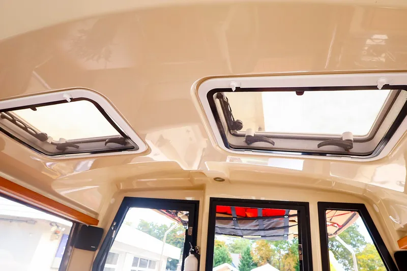 Slide: The Image of Interior view of 2023 Ranger Tugs R-27 boat, featuring dual skylights and modern design. - 19