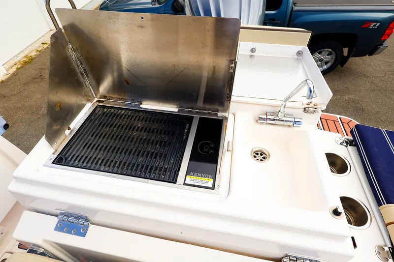 Slide: The Image of Outdoor grill and sink on 2023 Ranger Tugs R-27 boat deck. - 14