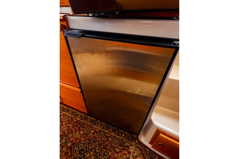Slide: The Image of Stainless steel refrigerator in 2023 Ranger Tugs R-27 boat interior. - 24