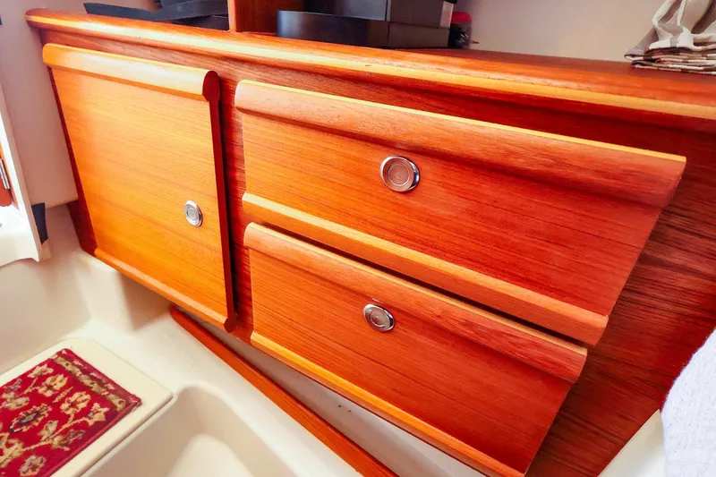 Slide: The Image of Wooden cabinetry inside a 2023 Ranger Tugs R-27 boat, featuring sleek design and polished finish. - 42