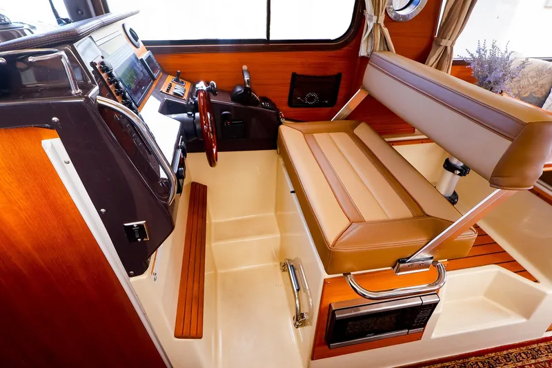 Slide: The Image of 2023 Ranger Tugs R-27 interior helm with leather seating and modern controls. - 26