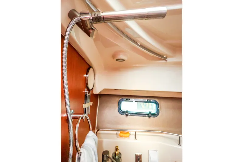 Slide: The Image of Interior of 2023 Ranger Tugs R-27 boat bathroom with shower and porthole window. - 45