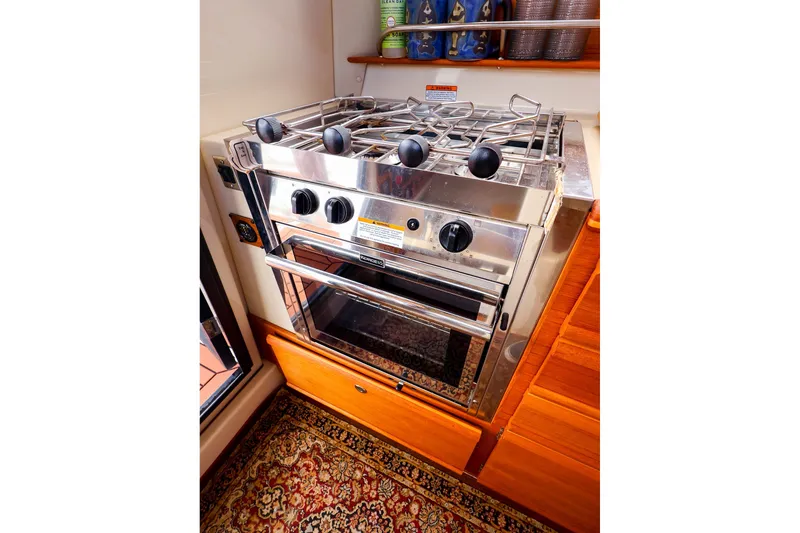 Slide: The Image of Stainless steel stove and oven in 2023 Ranger Tugs R-27 boat interior. - 22