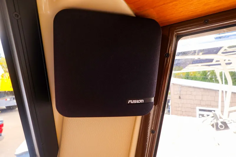 Slide: The Image of Fusion speaker inside 2023 Ranger Tugs R-27 boat, mounted near window. - 38