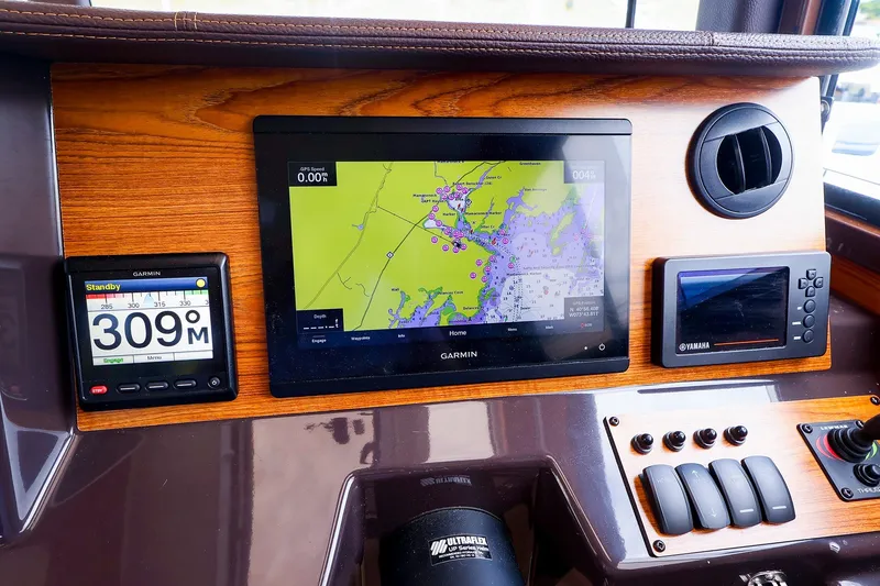 Slide: The Image of Dashboard of 2023 Ranger Tugs R-27 with Garmin navigation and control systems. - 30