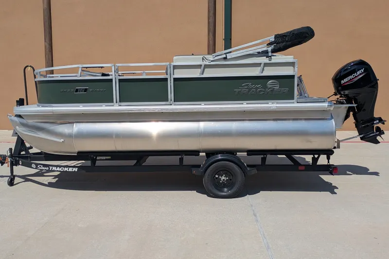 The Image of 2027 Sun Tracker Bass Buggy 16 XL Select pontoon boat on trailer, side view. - 0
