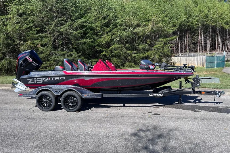 Slide: The Image of 2027 Nitro Z19 XL Pro boat on trailer, parked outdoors with forest background. - 4
