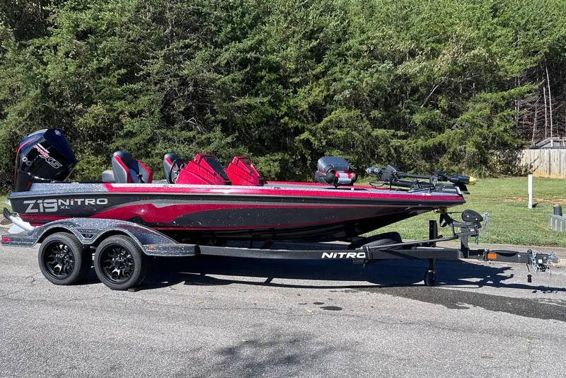 Slide: The Image of 2027 Nitro Z19 XL Pro bass boat on trailer, parked outdoors. - 2