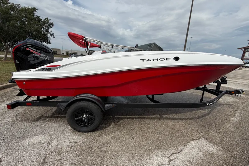Slide: The Image of 2027 Tahoe T18 boat with red and white design on a trailer, parked outdoors. - 6