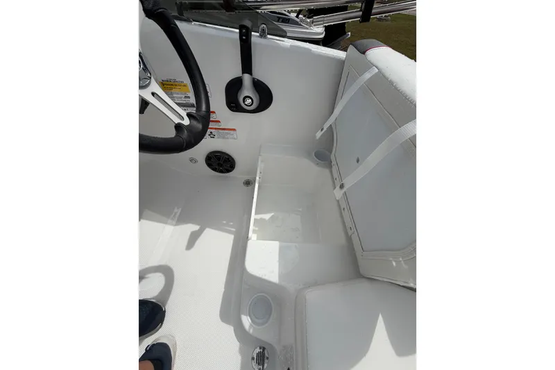 Slide: The Image of Interior view of 2027 Tahoe T18 boat, featuring steering wheel and seating area. - 14