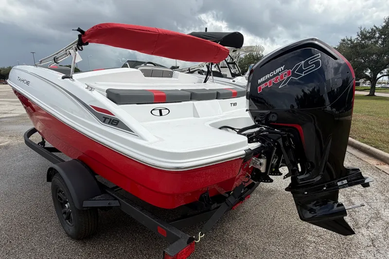 Slide: The Image of 2027 Tahoe T18 boat with Mercury Pro XS engine on a trailer, parked outdoors. - 4