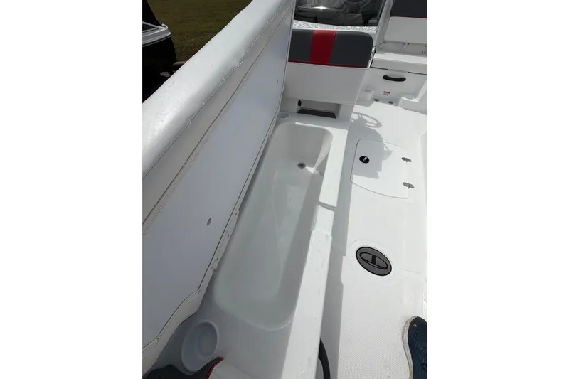 Slide: The Image of 2027 Tahoe T18 boat interior with white seating and storage compartment. - 12
