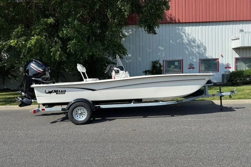 The Image of 2027 Mako Pro Skiff 17 CC boat on trailer, parked outdoors. - 0