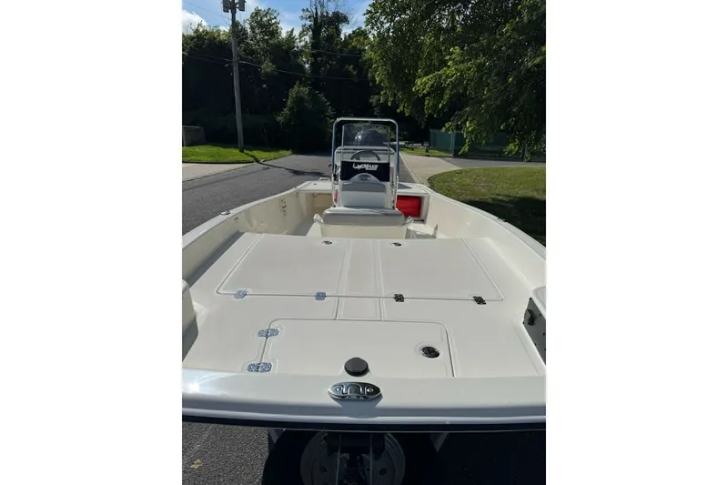 Slide: The Image of 2027 Mako Pro Skiff 17 CC boat with spacious deck and center console. - 6
