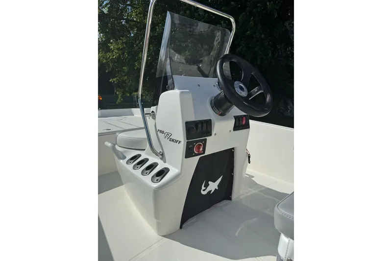 Slide: The Image of 2027 Mako Pro Skiff 17 CC boat console with steering wheel and controls. - 9
