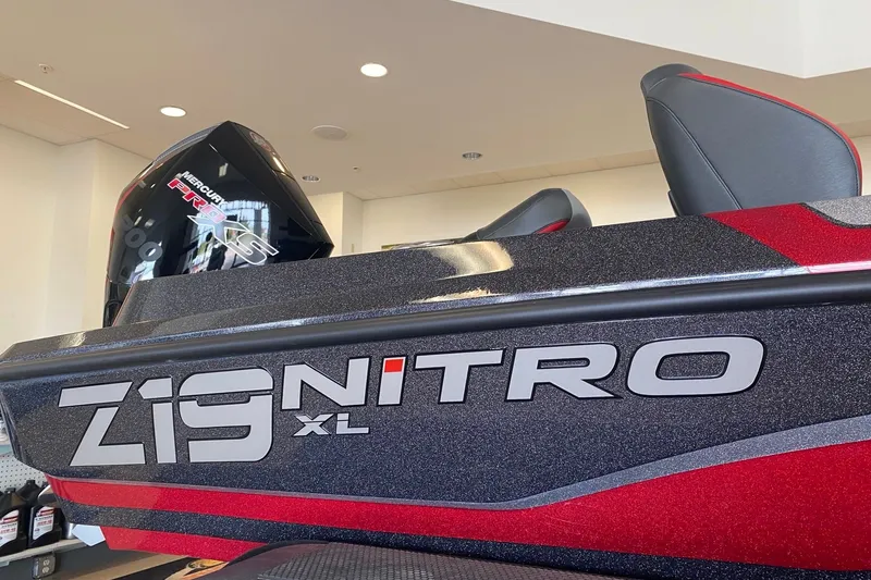 Slide: The Image of 2027 Nitro Z19 XL Pro boat with Mercury engine, sleek design in showroom. - 1