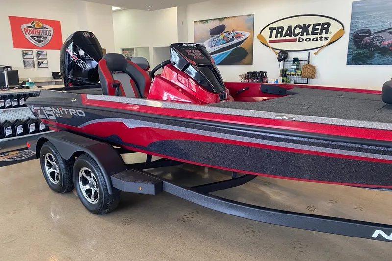 Slide: The Image of 2027 Nitro Z19 XL Pro boat in showroom, featuring sleek red and black design. - 2