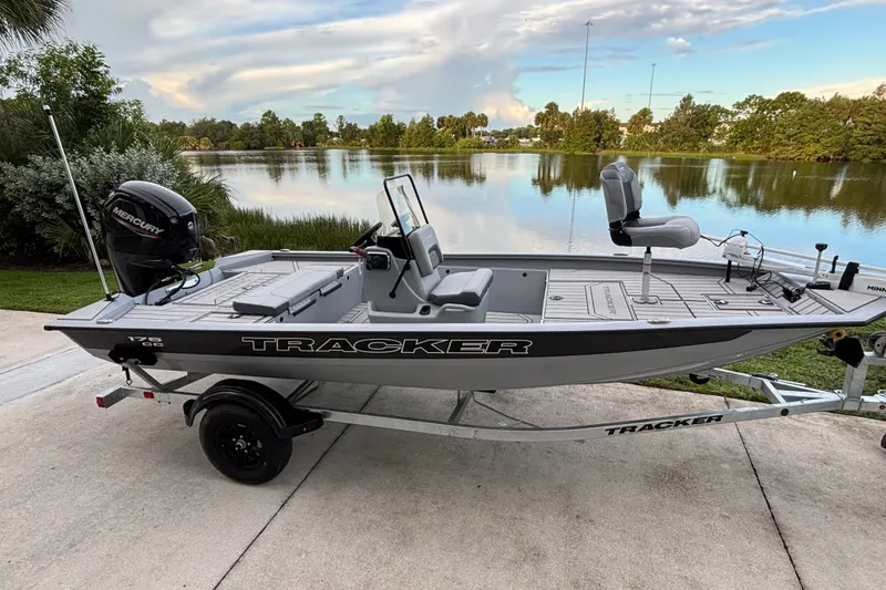 Slide: The Image of 2027 Tracker Bass Tracker 175 CC boat on trailer by a scenic lake. - 15