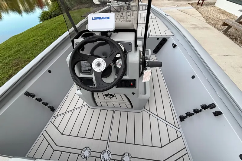 Slide: The Image of 2027 Tracker Bass Tracker 175 CC boat interior with steering wheel and Lowrance device. - 13