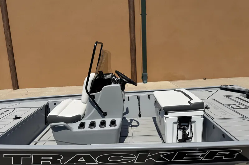 Slide: The Image of 2027 Tracker Bass Tracker Classic CC boat interior with steering console and seating. - 14