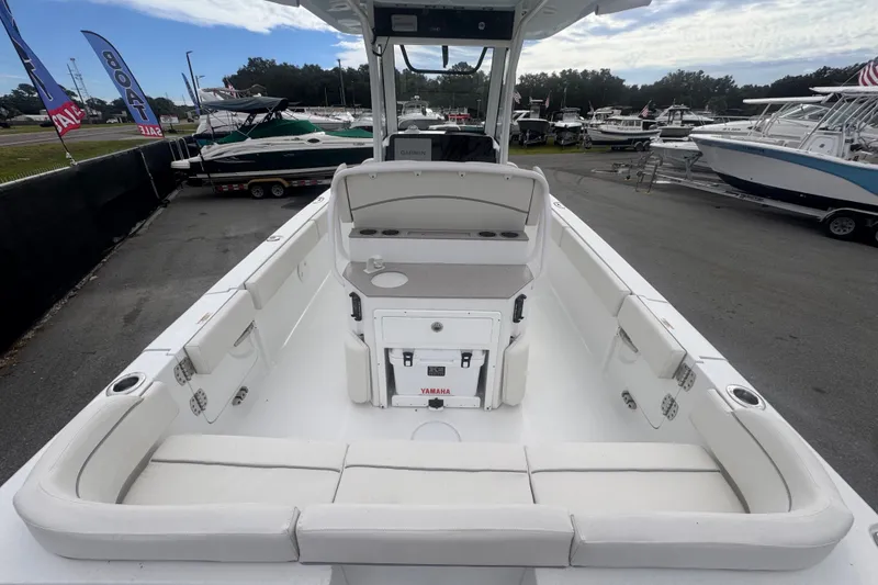 Slide: The Image of 2024 Sea Hunt Escape 25 boat interior with seating and Yamaha equipment, displayed at a boat sale. - 17