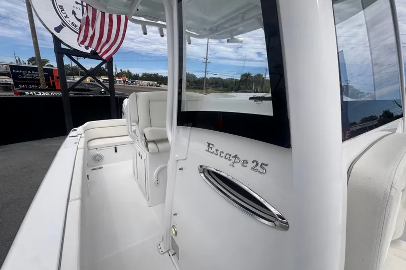 Slide: The Image of 2024 Sea Hunt Escape 25 boat interior with white seating and American flag. - 61