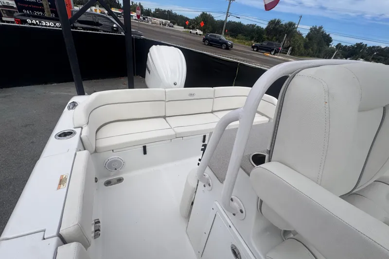 Slide: The Image of 2024 Sea Hunt Escape 25 boat interior with white seating and modern design. - 65