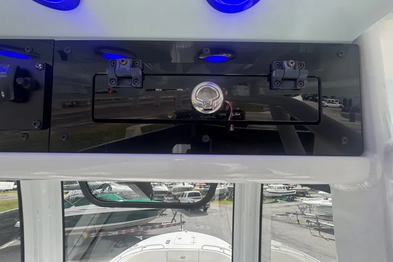 Slide: The Image of 2024 Sea Hunt Escape 25 boat dashboard with control panel and blue LED lights. - 40
