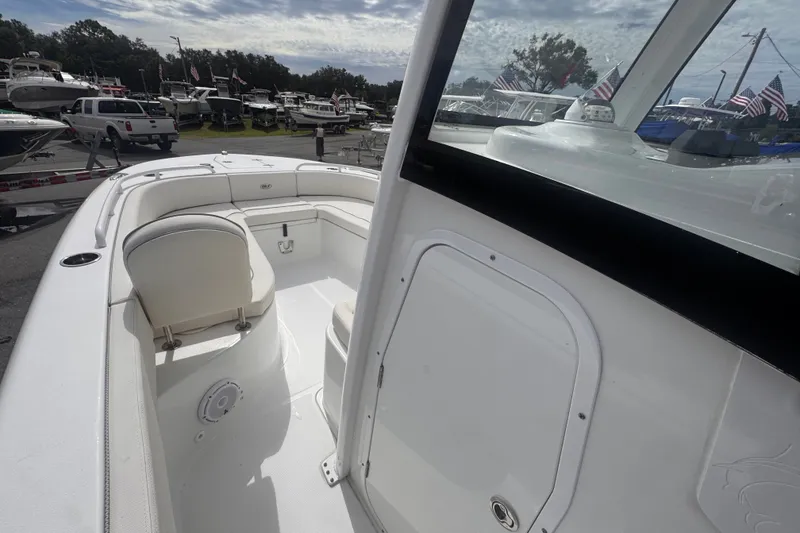 Slide: The Image of 2024 Sea Hunt Escape 25 boat interior with seating and storage, displayed outdoors. - 44