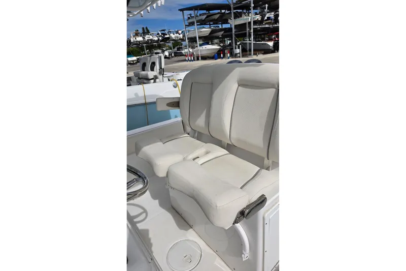 Slide: The Image of 2024 Sea Hunt Escape 25 boat interior with white cushioned seating. - 11