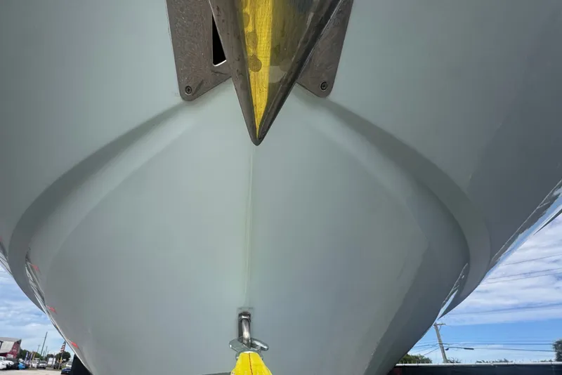 Slide: The Image of 2024 Sea Hunt Escape 25 boat hull, viewed from below, with a yellow strap attached. - 14