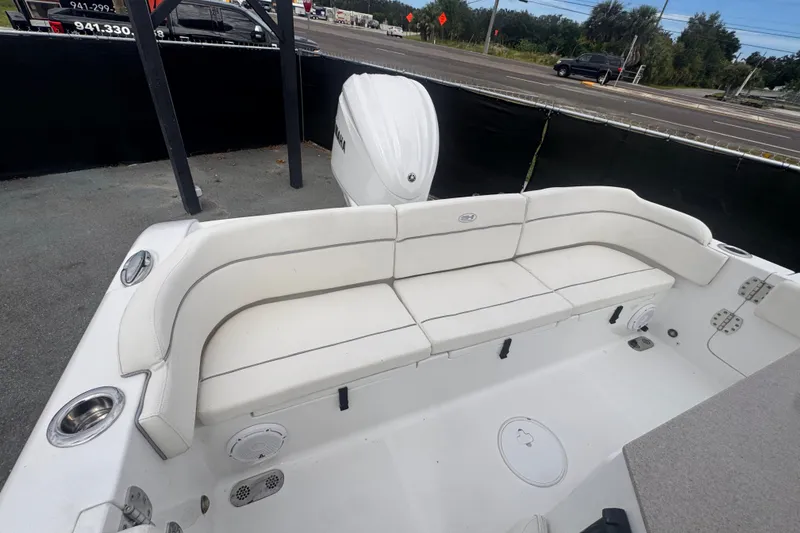 Slide: The Image of 2024 Sea Hunt Escape 25 boat interior with white seating and cup holders. - 66