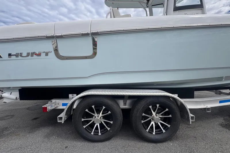 Slide: The Image of 2024 Sea Hunt Escape 25 boat on trailer, showcasing sleek design and modern features. - 71