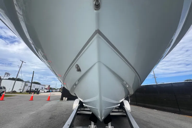Slide: The Image of 2024 Sea Hunt Escape 25 boat on trailer, viewed from front, under cloudy sky. - 15